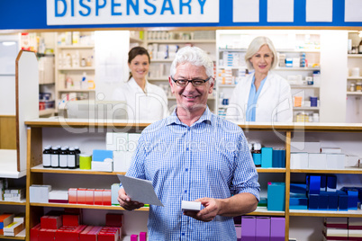 Customer holding prescription while checking medicine in pharmac