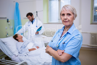 Portrait of nurse standing with arms crossed