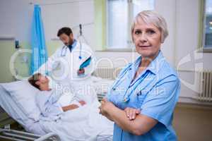 Portrait of nurse standing with arms crossed