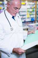 Pharmacist reading prescriptions