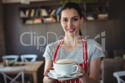 Female baker holding a cup of coffee