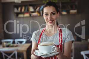 Female baker holding a cup of coffee