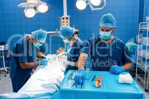 Surgeons performing operation in operation room