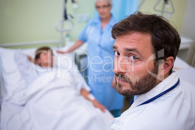 Portrait of doctor standing in hospital room