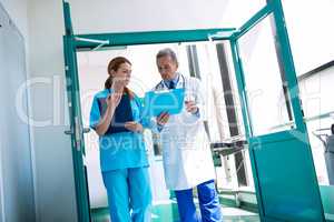 Doctor and nurse checking medical report