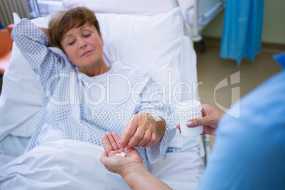 Nurse giving medication to patient