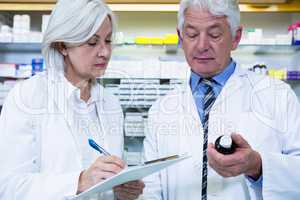 Pharmacists checking and writing prescription for medicine