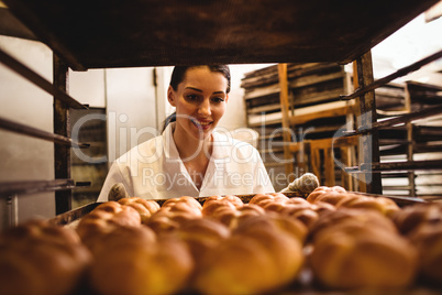 Female baker holding a tray of michetta