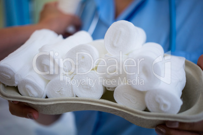 Nurse holding a tray of bandage