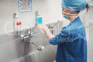 Female surgeon washing her hands
