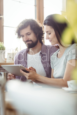 Couple using digital tablet