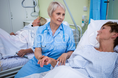 Nurse examining patients pulse