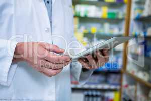 Pharmacist using a digital tablet