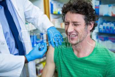 Pharmacist giving injection to patient