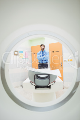 Portrait of doctor standing near mri scanner