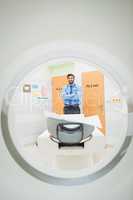 Portrait of doctor standing near mri scanner