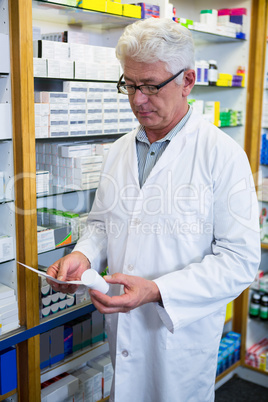 Pharmacist holding a prescription and medicine