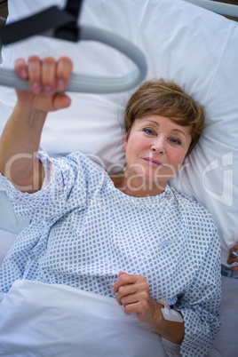 Portrait of smiling patient lying on bed