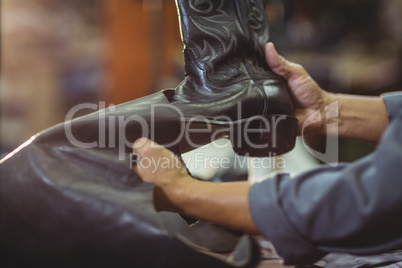 Cobbler making leather boots