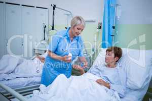 Nurse giving medication to patient