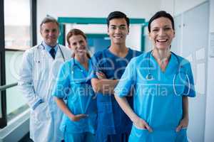 Portrait of smiling surgeons and doctors standing in corridor