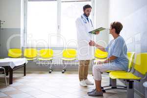 Doctor shaking hand with patient in waiting room