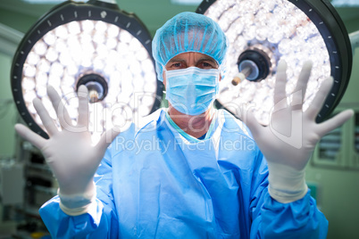 Portrait of surgeon preparing for operation in operation room