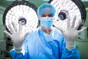 Portrait of surgeon preparing for operation in operation room