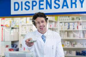 Pharmacist giving money to customer in pharmacy