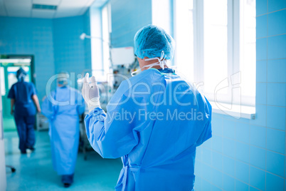 Rear view of surgeon walking in operation room