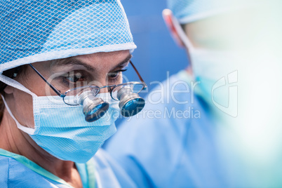 Surgeon looking through surgical loupes in operation room