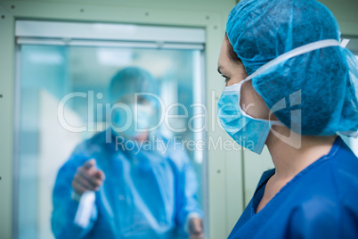 Doctor looking through a glass window