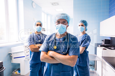 Portrait of surgeon and nurses standing in hospital