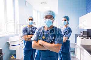 Portrait of surgeon and nurses standing in hospital