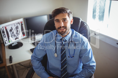 Portrait of doctor sitting at his desk