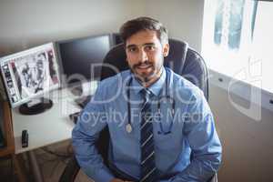 Portrait of doctor sitting at his desk