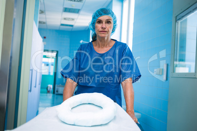 Portrait of nurse pushing empty stretcher