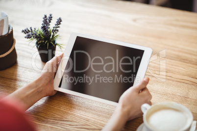 Hands of woman using digital tablet