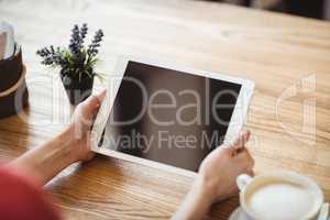 Hands of woman using digital tablet