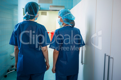 Surgeons standing in corridor at hospital