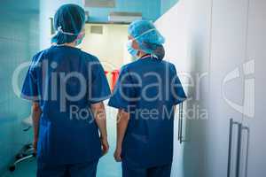 Surgeons standing in corridor at hospital