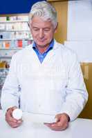 Pharmacist holding a prescription and medicine