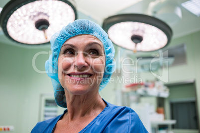 Smiling surgeon standing in operation room