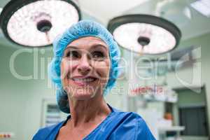 Smiling surgeon standing in operation room