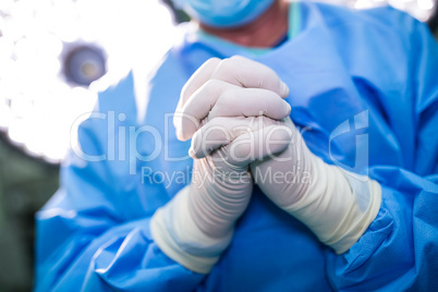 Surgeon praying in operation room while operation