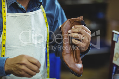 Shoemaker repairing a shoe