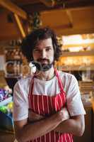 Portrait of male baker standing with arms crossed