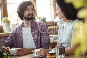 Couple interacting with each other while having coffee