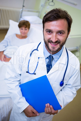 Smiling doctor holding a medical report