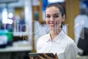 Pharmacist using digital tablet in pharmacy